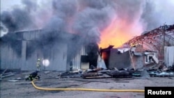 Firefighters work at the site of storage facilities hit by a Russian missile strike, amid Russia's attack on Ukraine, in Dnipro, Ukraine, April 28, 2023.