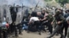 NATO Kosovo Force (KFOR) soldiers clash with local Kosovo Serb protesters at the entrance of the municipality office, in the town of Zvecan, Kosovo, May 29, 2023.
