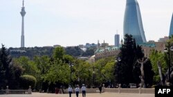 FILE - Police officers patrol in Baku, Azerbaijan, May 18, 2020.