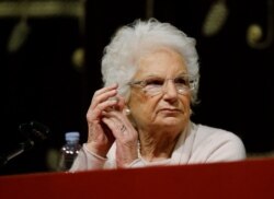 FILE - Holocaust survivor Liliana Segre speaks with young students on the occasion of a Holocaust remembrance at the Arcimboldi theatre in Milan, Jan. 24, 2018.