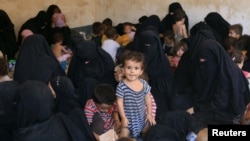Families and relatives of Islamic State militants are seen after they surrendered themselves to the Kurdish Peshmerga forces in al-Ayadiya, northwest of Tal Afar, Iraq, Aug. 30, 2017.