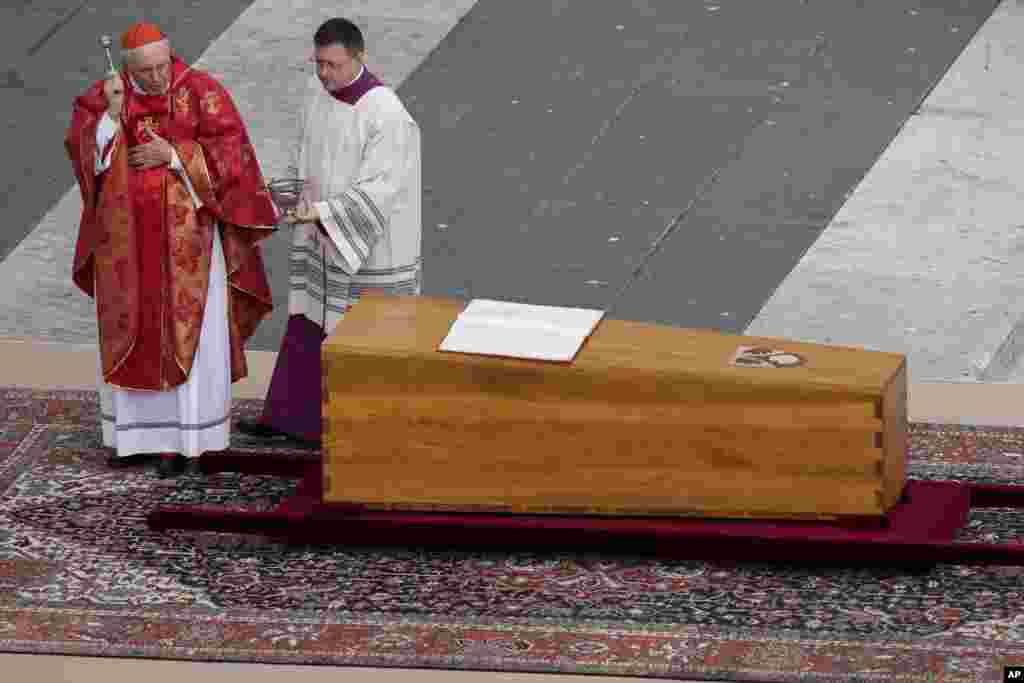 Cardinal Giovanni Battista Re blesses the coffin of late Pope Emeritus Benedict in St. Peter's Square at the Vatican, Jan. 5, 2023.