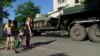 Russian military vehicles move through the city of Mariupol on July 15, 2022, amid the ongoing Russian military action in Ukraine. 