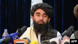 FILE - Taliban spokesperson Zabihullah Mujahid looks on as he addresses the first press conference in Kabul on Aug. 17, 2021.