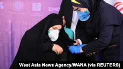  Seorang perawat bersiap menyuntikkan sukarelawan yang ikut serta dalam uji coba vaksin Covid-19 Iran di Teheran, Iran 29 Desember 2020. (Foto: West Asia News Agency/WANA via Reuters)