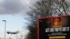 FILE - A plane comes in to land near a government coronavirus sign at Heathrow Airport in London, Britain, Feb. 5, 2021.