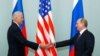 This combination of file pictures created on Jan. 26, 2021 shows President Joe Biden, left, speaking in the State Dining Room of the White House on Jan. 20, 2021, and Russian President Vladimir Putin holding a press conference in Moscow on Dec. 19, 2019.