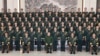 In this photo released by Xinhua News Agency, Chinese President Xi Jinping poses for photos with military personnel of the Chinese People's Liberation Army garrison stationed in the Macao Special Administrative Region in southern China, Dec. 20, 2024. (Li Gang/Xinhua via AP)