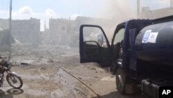 This image taken in Sept. 30, 2015 posted on the Twitter account of Syria Civil Defense, also known as the White Helmets, a volunteer search and rescue group, shows the aftermath of an airstrike in Talbiseh, Syria.