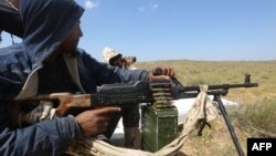 Fighters loyal to Libya's Government of National Accord (GNA) hold a position west of the city of Aziziah, some 60 kilometers southwest of the capital Tripoli, April 14, 2019. 
