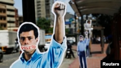 FILe - Cardboard figures of jailed opposition leader Leopoldo Lopez with his mouth covered with the word 'Crime' are seen during a gathering in support of him in Caracas June 4, 2014.