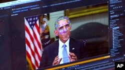 FILE - This image made from video of a fake video featuring former President Barack Obama shows elements of facial mapping used in new technology that lets anyone make videos of real people appearing to say things they've never said. 