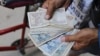Long lines, frustration grow as Cuba runs short of cash