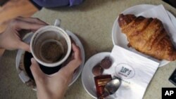 FILE - Coffee grounds shown in a customer's coffee cup at a shop.
