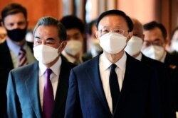 FILE - Yang Jiechi, right, director of the Central Foreign Affairs Commission Office for China, and Chinese Foreign Minister Wang Yi arrive for a meeting with U.S. counterparts in Anchorage, Alaska, March 18, 2021.