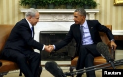 FILE - U.S. President Barack Obama and Israeli Prime Minister Benjamin Netanyahu shake hands during their meeting in the Oval Office of the White House in Washington, Nov. 9, 2015.