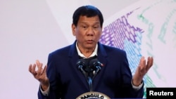FILE - Philippines' President Rodrigo Duterte gestures during a news conference at the Association of South East Asian Nations (ASEAN) summit in Pasay, metro Manila, Philippines, Nov. 14, 2017.