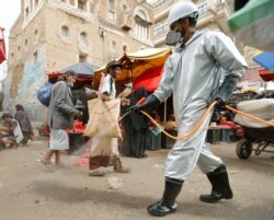 A health worker wearing a protective suit disinfects a market amid concerns of the spread of the coronavirus disease (COVID-19), in Sanaa, Yemen, April 28, 2020.