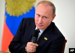 FILE - Russian President Vladimir Putin speaks to Russian journalists following the BRICS summit in Goa, India, Oct. 16, 2016.