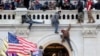 FILE - A mob of supporters of U.S. President Donald Trump fight with members of law enforcement at a door they broke open as they storm the U.S. Capitol Building in Washington, Jan. 6, 2021. 