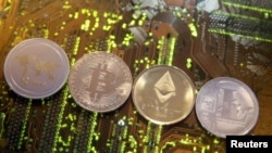 FILE - Representations of the Ripple, Bitcoin, Etherum and Litecoin virtual currencies.