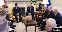 FILE - South Korea's national security chief, Chung Eui-yong, briefs U.S. President Donald Trump at the Oval Office about his visit to North Korea, March 8, 2018.