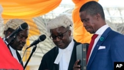 Edgar Lungu, right, is sworn in as president at an inauguration ceremony in Lusaka, Zambia, Jan. 25, 2015.