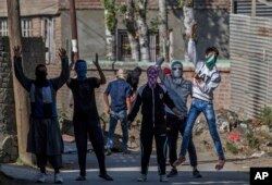 FILE - Masked Kashmiri protesters shout pro-freedom slogans during a protest in Srinagar, Indian-controlled Kashmir, Oct. 14, 2016.