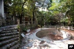 photo shows the remains of Habitation Leclerc in Port-au-Prince, Haiti. In the ruins, a group of abandoned children found shelter but were barely surviving.