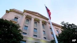 FILE - The Department of Justice headquarters building in seen in Washington, May 14, 2013.