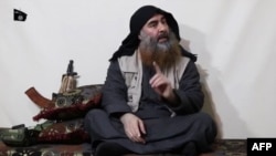 The chief of the Islamic State group, Abu Bakr al-Baghdadi, purportedly appears for the first time in five years in a propaganda video in an undisclosed location, in this undated TV grab taken from video released April 29 by Al-Furqan media.