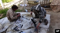 Militan ISIS membersihkan senjata mereka di Deir el-Zour, Suriah, 16 Juni 2015 (Foto: dok).