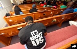 A woman listens to Black Voters Matter co-founder LaTosha Brown speak at a church as part of The South Is Rising Tour 2018, Aug. 22, 2018, in Warner Robins, Ga.