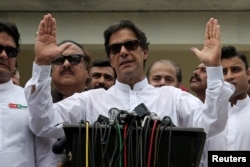 Cricket star-turned-politician Imran Khan, chairman of Pakistan Tehreek-e-Insaf (PTI), speaks to members of media after casting his vote at a polling station during the general election in Islamabad, Pakistan, July 25, 2018.