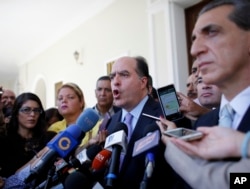 Julio Borges, center, President of Venezuela's National Assembly, speaks during a news conference prior the start of a session of Congress in Caracas, Venezuela, Aug. 2, 2017.