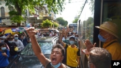 FILE - Anti-coup protesters shout slogans during a demonstration, May 6, 2021, in Yangon, Myanmar.