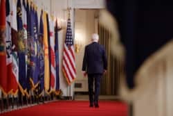 U.S. President Joe Biden departs down the Cross Hall of the White House after delivering his first prime-time address as president, March 11, 2021.