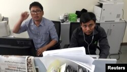 FILE - Reuters journalists Wa Lone, left, and Kyaw Soe Oo, who are based in Myanmar, pose for a picture at the Reuters office in Yangon, Myanmar, Dec. 11, 2017. 