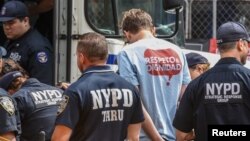 A person from the group called "Make the Road" is detained while protesting in support for the Deferred Action for Childhood Arrivals or DACA during the United Nations General Assembly in New York City, Sept. 19, 2017.