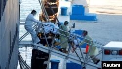 Rescue workers transport a patient from the Zaandam cruise ship of the Holland America Line afflicted with coronavirus disease (COVID-19), at Port Everglades in Fort Lauderdale, Fla., April 2, 2020.