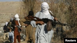 FILE - Armed Taliban fighters are seen at an unidentified location in Nangarhar province, Afghanistan, Dec.13, 2010. Taliban fighters are currently launching a new spring offensive.