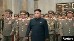 FILE - North Korean leader Kim Jong Un, with troops, visits the Kumsusan Palace on the anniversary of the armistice signing that ended the Korean War. Photo released by North Korea's Korean Central News Agency in Pyonghyang July 27, 2014.