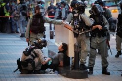 Police detained a protester during a march marking the anniversary of the Hong Kong handover from Britain to China, July. 1, 2020, in Hong Kong.