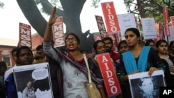 A member of a students organization shouts slogans as others carry placards asking justice for Asifa Mohammad Yusuf Pujwala, an 8-year-old girl who was raped and murdered, during a protest in Bangalore, India, April 13, 2018. Thousands of members of a radical Hindu group with links to the ruling party have marched to demand the release of six men accused in the repeated rape and murder of the Muslim girl inside a Hindu temple. Hundreds of Hindu lawyers have protested that the men, two of them police officers, are innocent.