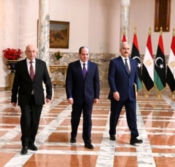 FILE - A handout picture released by the Egyptian Presidency June 6, 2020, shows Egyptian President Abdel Fattah al-Sissi (C), Libyan commander Khalifa Haftar (R) and Libyan Parliament speaker Aguila Saleh arriving for a press conference in Cairo.