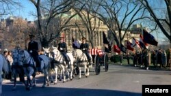 The funeral caisson carrying the casket of former U.S. President John F. Kennedy enters the White House driveway in Washington, in this handout image taken on Nov. 25, 1963.