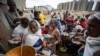 Des Tigréens déplacés font la queue pour recevoir de la nourriture donnée par des résidents locaux dans un centre d'accueil pour personnes déplacées à Mekele, dans la région du Tigré au nord de l'Éthiopie le dimanche 9 mai 2021. (AP Photo/Ben Curtis)